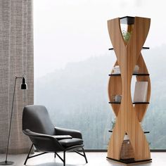 a chair sitting next to a tall wooden shelf