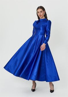 Step into elegance with this stunning royal blue satin dress, designed for the modern woman who appreciates unique details. The dress features a fitted bodice that gracefully transitions into a voluminous full skirt, creating a timeless silhouette. The highlight of this dress is the beautifully embellished shoulder detail, adding a touch of sparkle and sophistication. Perfect for formal events, weddings, or any special occasion, this dress ensures you stand out with its luxurious fabric and meticulous craftsmanship. The high neckline and long sleeves offer a refined and regal look, making this dress a must-have for your wardrobe. Color: Royal Blue Material: Satin Details: Embellished shoulder, full skirt Occasion: Formal events, weddings, special occasions Care Instructions: Dry clean only Royal Blue Satin Dress, Blue Satin Dress, Wardrobe Color, Blue Satin, Satin Dress, High Neckline, Fitted Bodice, Full Skirt, Dress Clothes For Women