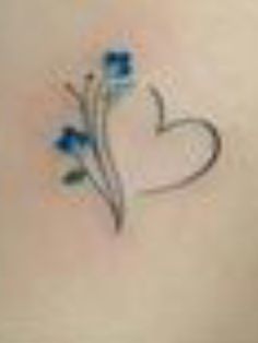 a woman's stomach with three blue flowers on it and a heart drawn in the middle