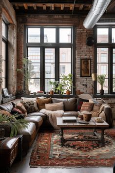 a living room filled with lots of furniture and large windows in front of the brick wall