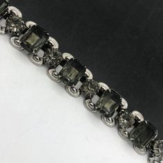 Vintage 1960's Bracelet, Retro Gray Jewelry, Gray Rhinestone Chunky Wide Bracelet, Old Hollywood Glam, Mid-Century Jewelry, Collectible Jewelry In very good vintage condition...  Measures: 7 inches long by 1 inch wide. Marked: none Dates: 1950's 1960's Hope you enjoy.... FYI.... I am always listing many items from vintage purses, compacts, vintage jewelry to collectibles Hope you are able to come back often... Stop on by for a lot more .... www.etsy.com/shop/martinimermaid #vintage #gray #chunky Vintage Silver Jeweled Bracelets, Retro Jeweled Bracelets For Formal Occasions, Retro Jeweled Bracelet For Formal Occasions, Vintage Bracelets With Sparkling Stones For Formal Occasions, Vintage Formal Bracelets With Sparkling Stones, Vintage Silver Crystal Bracelet With Jewels, Vintage Silver Crystal Bracelet With Sparkling Stones, Silver Costume Jewelry Bracelets For Evening, Vintage Jubilee Bracelet For Party