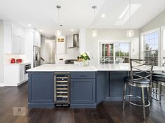 a kitchen with blue cabinets and white counter tops