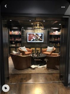 a living room filled with furniture and a flat screen tv mounted to the side of a wall