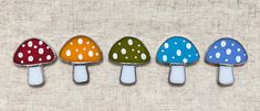 four different colored mushrooms sitting next to each other