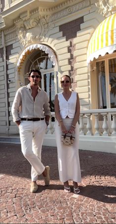 the man and woman are walking together outside