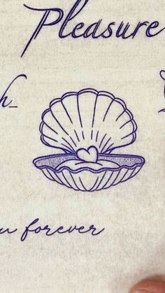 a hand holding a piece of paper with writing on it and an image of a seashell