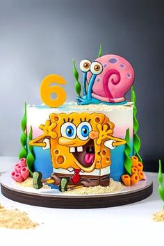 a birthday cake with an image of a cartoon character on it and the number six