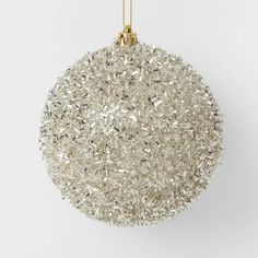 a white ornament hanging from a gold chain