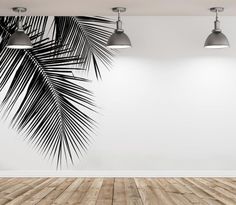 an empty room with two lamps and a palm tree wall mural on the wall behind it