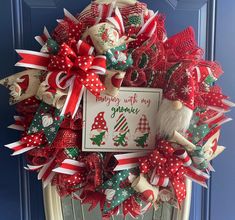 a christmas wreath on the front door with santa's helper and gnomes