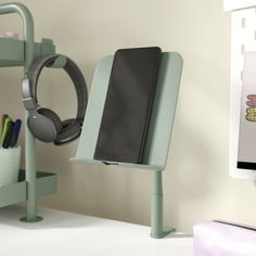 a computer desk with headphones on it