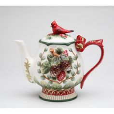 a ceramic teapot with a bird on top