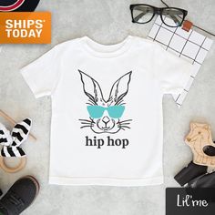 "Our Award-Winning LilMe© threads are 100% designed, printed, pressed and shipped (next business day!) to you from our Upstate New York boutique. ** Quick Sizing Tip ** Onesies are printed on Gerber organic. These tend to run small so we recommend sizing up if you are on the fence. Toddler shirts are true to size. 📋 HOW TO ORDER: ✧ Choose onesie® or shirt size (sizing chart below) and sleeve length ✧ Select design color if applicable ✧ For personalized designs - enter customization in \"Add you Unisex Printed White Tops, Unisex White Printed Tops, Fitted Screen Print Shirt For Spring, Playful Custom Print Tops For Spring, White Letter Print Top For Easter, Easter-themed White Tops With Letter Print, Easter White Letter Print Tops, Playful Pre-shrunk Shirt For Spring, Unisex Custom Print Shirt For Summer