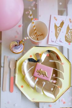 a table topped with plates and confetti