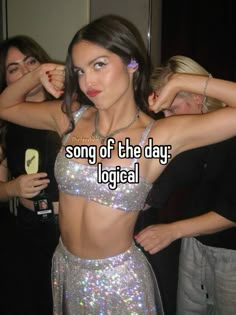 a woman in a silver dress with the words song of the day logical