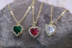 CZ rhinestone heart pendant necklace available in magenta pink, Emerald green ,or rhinestone. Dainty minimalistic CZ rhinestone gold heart pendant charm necklace High quality 18k gold plated  With adjustable chain - Length option of 14'' to 16'' ,or 16'' to 18''  chain. Dainty minimalistic pendant charm. Great as a gift ,or for yourself for that special occasion! Any questions feel free to ask! Thanks for supporting a small family run business! Comes packaged in a beautiful box ready to gift! Minimalistic Pendant, Green Heart Necklace, Vintage Heart Necklace, Heart Necklace Gold, Pink Heart Necklace, Pink Emerald, Gold Heart Pendant, Necklace Birthstone, Green Heart