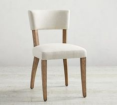 a white chair sitting on top of a wooden floor