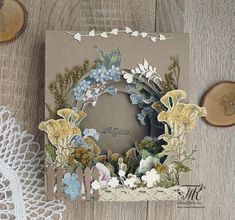 a close up of a card on a table with doily and lace next to it