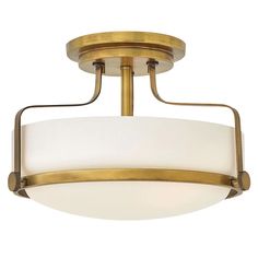 a semi - flush ceiling light fixture with white glass shades in an antique brass finish