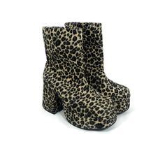 a pair of leopard print high heeled boots on a white background with no shoes