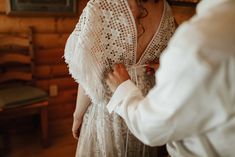 a woman in a white dress standing next to a man