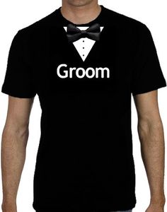 a man wearing a black t - shirt with the word groom on it and a bow tie around his neck