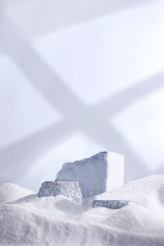 an ice block sitting on top of snow covered ground