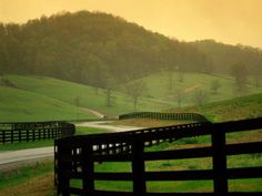 a fence with the words i'll take you up and down these holes and hills, let me show you how country feels