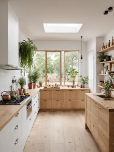 a kitchen filled with lots of wooden cabinets and counter top space next to a window