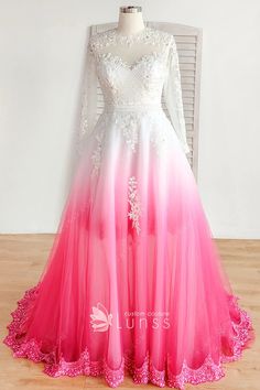 a pink and white wedding dress with long sleeves