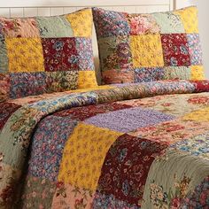 a bed with a colorful quilt on it