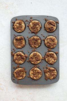 a muffin tray filled with cupcakes on top of a white countertop