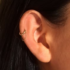 a close up of a person's ear with an ear cuff