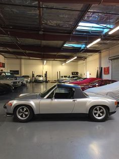 a car parked in a garage next to other cars