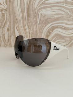 🖤🛸 Dior Ski 1, vintage Dior sunglasses  Ski mask vibes  Black lenses and white contrast arms with black Dior text logo  Comes with original sunglasses case and extras Condition: Very good vintage condition, and item which is older but has little flaws for the age, expect small marks, see images for a mark on lenses. Gorgeous and very rare! Open to offers. #dior #diorsunglasses #vintagedior #diorski #vintagesunglasses Trendy White Shield Sunglasses For Outdoors, Trendy White Shield Sunglasses For Outdoor, White Polarized Sunglasses For Streetwear, White Sunglasses With Mirrored Lenses For Streetwear, White Mirrored Sunglasses For Streetwear, White Tinted Sunglasses For Streetwear, Retro White Sunglasses With Mirrored Lenses, Vintage White Sunglasses With Polarized Lenses, Trendy White Anti-reflective Shield Sunglasses