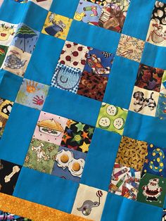 a close up of a patchwork quilt with many different colors and designs on it