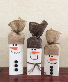 three snowmen made out of toilet paper and burlocks