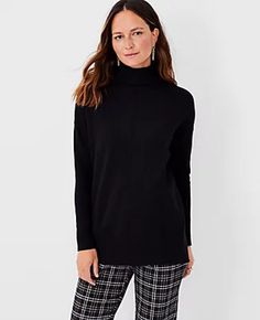 Styled with side slits for extra ease of movement, our turtleneck tunic sweater is perfect for the season. Turtleneck. Long sleeves. Drop shoulders. Side slits. Ribbed neck, cuffs and hem. • 28" long • 41% Polyester, 37% Viscose, 22% Nylon • Machine Washable • Imported 3199 Womens Black Sweater, Turtleneck Tunic Sweater, Ann Taylor Petite, Turtleneck Tunic, Knitted Suit, Fashion Jackson, Trendy Sweaters, Turtleneck Long Sleeve, Black Turtleneck