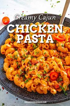 creamy cajun chicken pasta with tomatoes and parsley in a black bowl on a white table