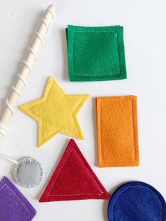 felt shapes are laid out on a white surface, including one star and the other triangle