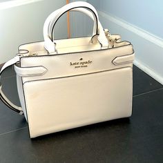 Never Used White Hand Bag Classic White Satchel With Top Carry Handle, Chic White Satchel With Top Carry Handle, Chic White Satchel With Handles, Classic White Handheld Bag, Kate Spade Handheld Shopping Bag, Modern Kate Spade Bags For Everyday Use, Modern Kate Spade Bags For Errands, White Tote Satchel With Gold-tone Hardware, White Satchel Tote With Gold-tone Hardware