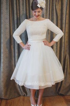 a woman is wearing a white dress with long sleeves and a flower in her hair