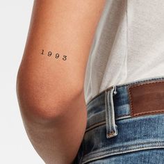 the back of a person's arm with an inscription on it that reads, 1989