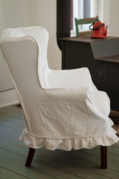 a white chair sitting on top of a hard wood floor