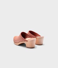 Made by skilled artisans in Sweden, these blush pink nubuck clog mules feature a high heel and eye-catching stud detailing on the sides. From date nights to ladies' nights out, Rome delivers unparalleled style and confidence. Clog measurements:Heel height: 2 5/8” (6.5 cm)Toe height:﻿ 1 1/2″ (3.8 cm) Fit:NarrowLeather:Nubuck leatherClogs consist of:Base: European Lime Wood Sole: Rubber sole Fastening: Brass studs Spring High Heel Clogs With Studded Rubber Outsoles, Pink Leather Mules With Sculpted Heel, Spring Slip-on Clogs With Studded Rubber Outsoles, Pink Leather Slip-on Mules, Summer Slip-on Clogs With Sculpted Heel, Pink Leather Clogs With Removable Insole, Suede Slip-on Mules With Wooden Heel, Suede Mules With Sculpted Heel And Round Toe, Pink Leather Mules With Block Heel