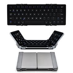 an open laptop computer keyboard sitting on top of a white surface next to another one