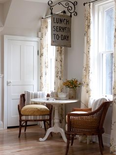 two chairs and a table in front of a window with the words lunch served to - day on it