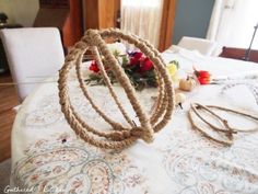 there are several pieces of rope on top of the dining room table with flowers in the background