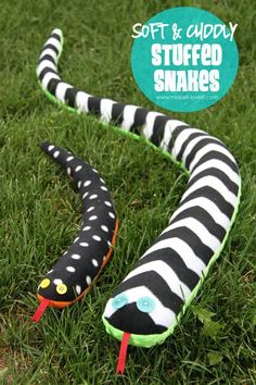 a stuffed snake is laying in the grass