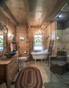 a bathroom with a tub, toilet and sink